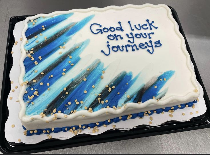 a birthday cake with blue and white frosting on it that says, good luck on your journey