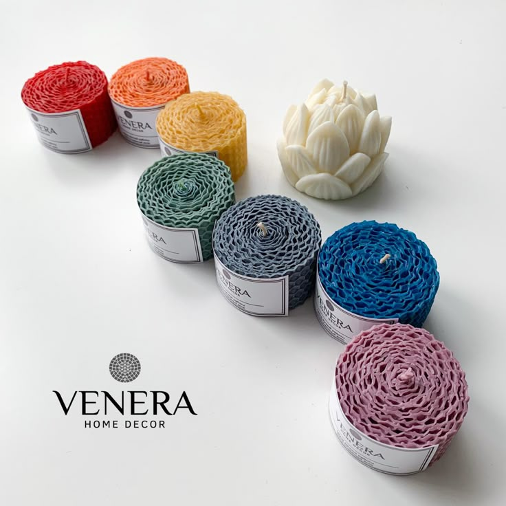 several rolls of yarn sitting next to each other on top of a white surface with the word, venera home decor