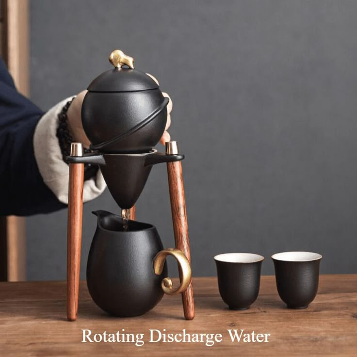 a coffee pot and three cups on a wooden table with the words rotating discharge water