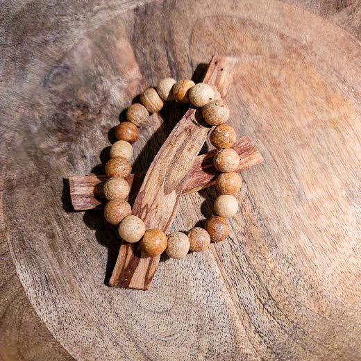 In Spanish, Palo Santo translates to "Holy Wood" and it grows in the coastal regions of South America. These bracelets are made of 100% palo santo wood and are very fragrant when worn. Spiritual Natural Wood Beaded Bracelets, Spiritual Wooden Beaded Bracelets, Holistic Wooden Beads Bracelets For Meditation, Adjustable Wood Spiritual Bracelets, Adjustable Wooden Spiritual Bracelets, Adjustable Wood Bracelets For Meditation, Natural Wooden Beads Spiritual Bracelet, Spiritual Adjustable Natural Wood Beaded Bracelets, Holistic Wooden Beads Healing Bracelet