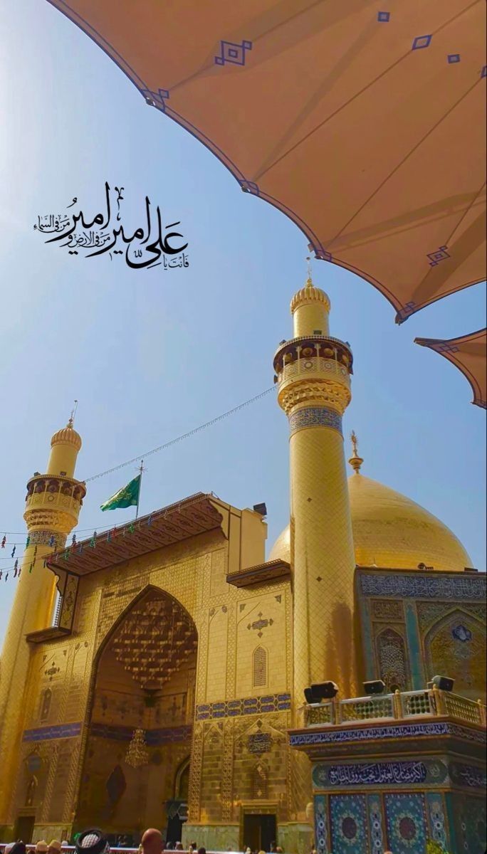 a large yellow building with two towers under an umbrella