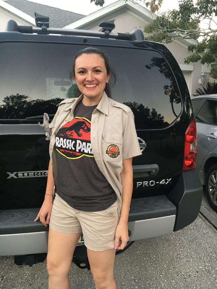 a woman standing in front of a black van