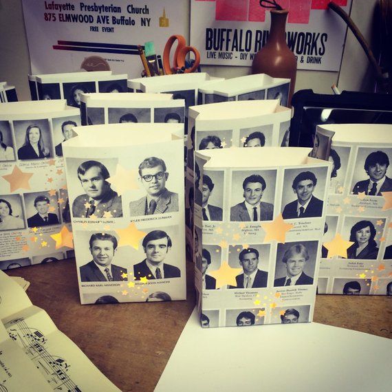 several small bags with pictures of people on them sitting on a table next to some papers