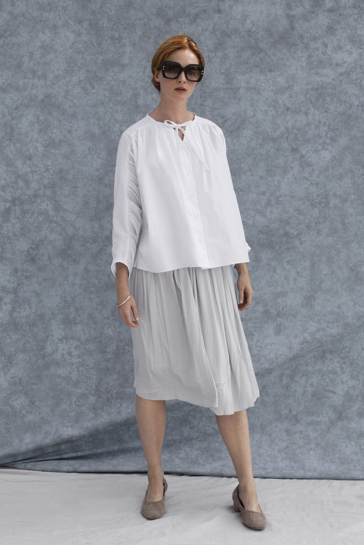 A modern take on a peasant top with gathering all up and down the slightly-cropped dolman sleeves. This loose, airy top is perfect for warmer days throughout the spring, summer and fall. 100% organic cotton. Made in NYC to the highest standards of design and sustainability. 3/4 Sleeve Shirt For Fall Daywear, White Relaxed Fit Half Sleeve Blouse, White Long Sleeve Blouse With Rolled Sleeves, White Blouse With Rolled Long Sleeves, White Long Sleeve Blouse For Casual Gatherings, White Long Sleeve Top With Rolled Sleeves, Relaxed Fit Half Sleeve Top For Layering, Fall 3/4 Sleeve Shirt With Relaxed Fit, Relaxed Fit Tops With 3/4 Sleeve For Daywear