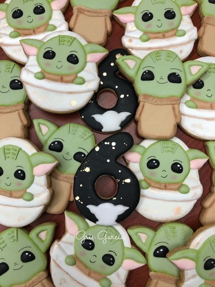 there are many decorated cookies in the shape of baby yoda's