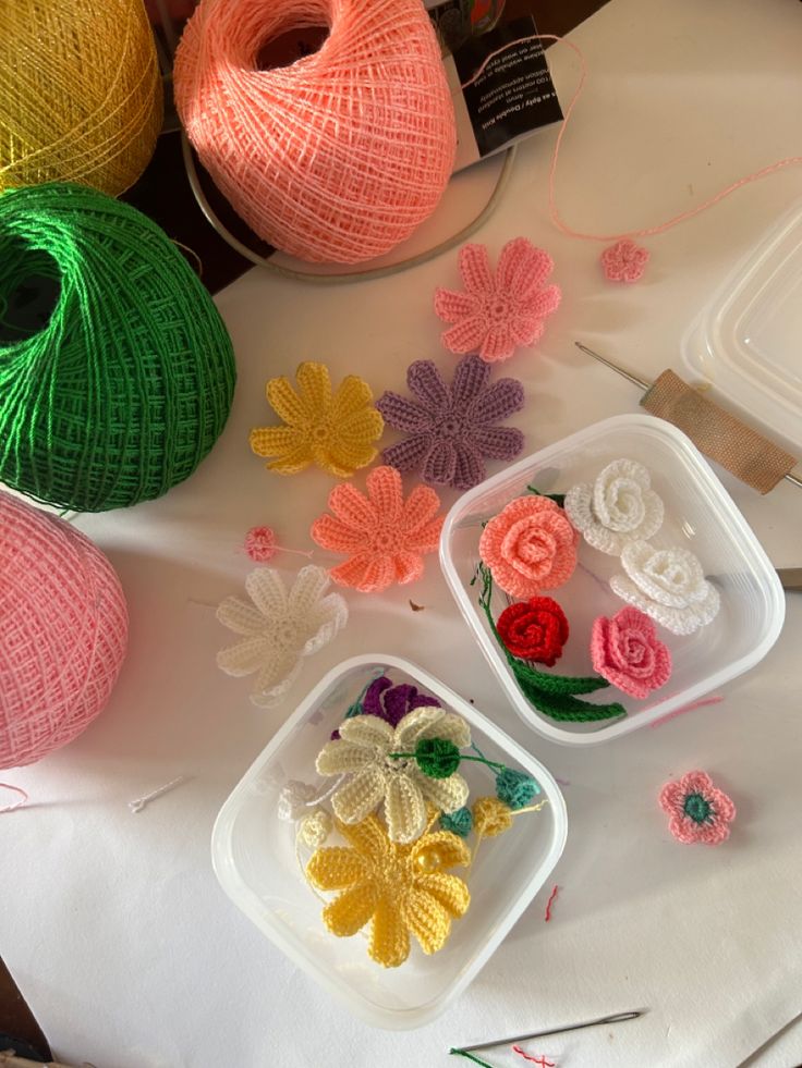 crochet flowers and yarn on a table