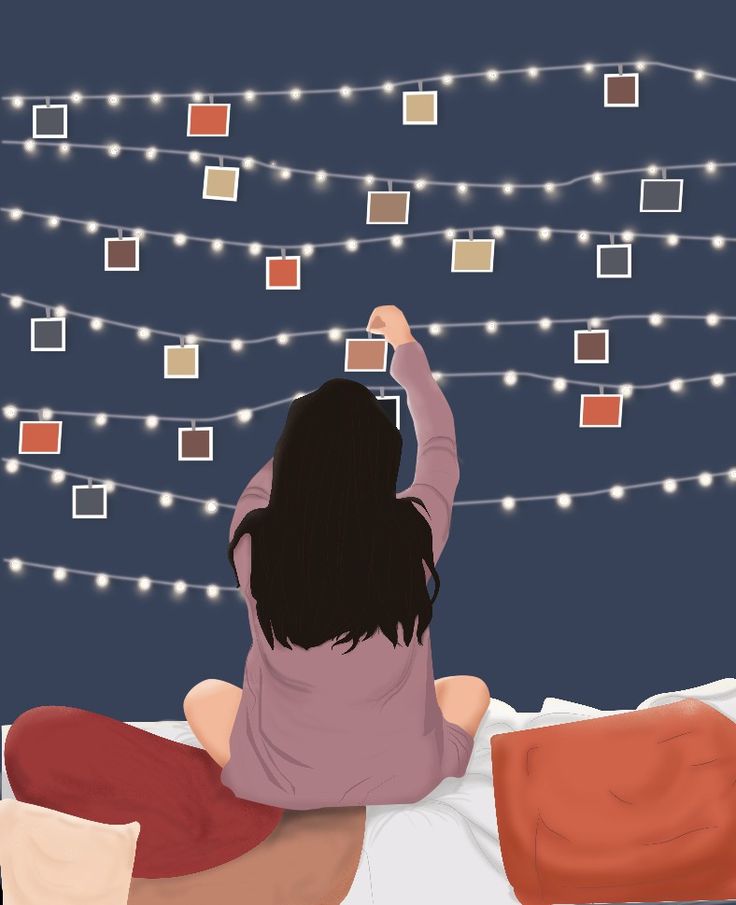 a woman is sitting on her bed looking at the lights