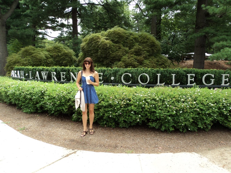 a woman standing in front of a college sign