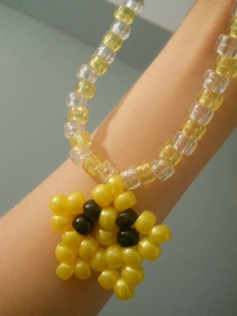 a close up of a person's arm wearing a bracelet made out of beads