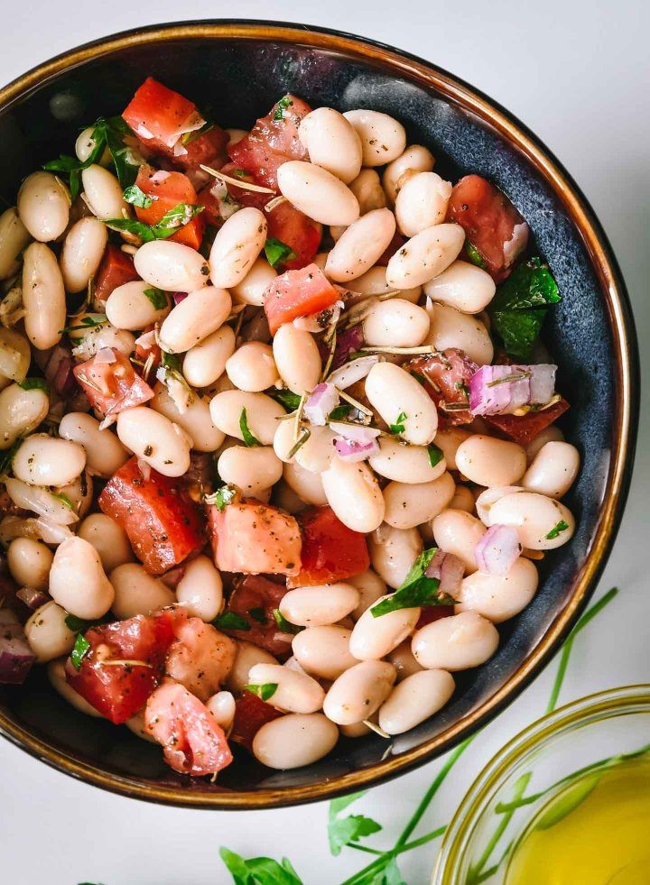 a bowl filled with white beans and vegetables