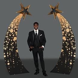 a man standing in front of a black and gold decorated crescent with stars on it