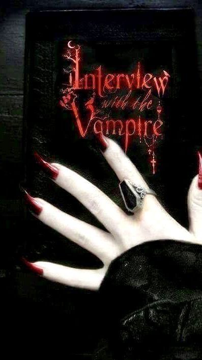 an image of a vampire hand with red nails