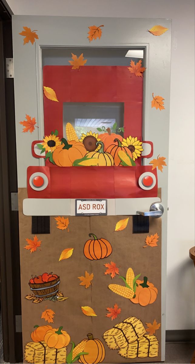 an atm machine decorated with fall leaves and pumpkins