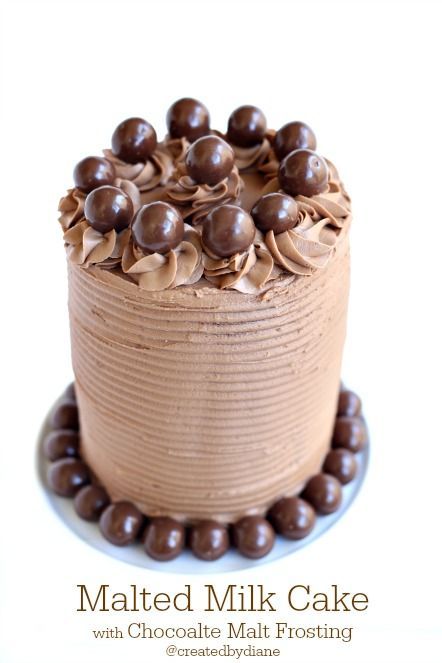 a cake with chocolate frosting and nuts on top