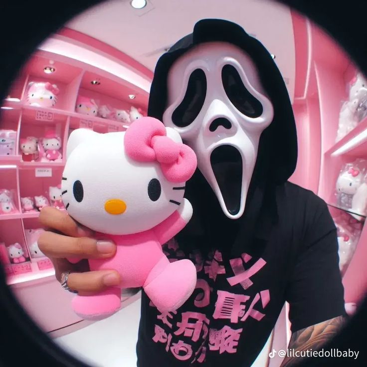 a person wearing a hello kitty mask holding a stuffed animal