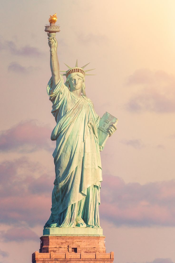 the statue of liberty is holding an apple in its hand