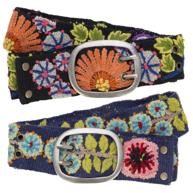 two colorful belts with metal buckles and flowers on the bottom one has a flowered design