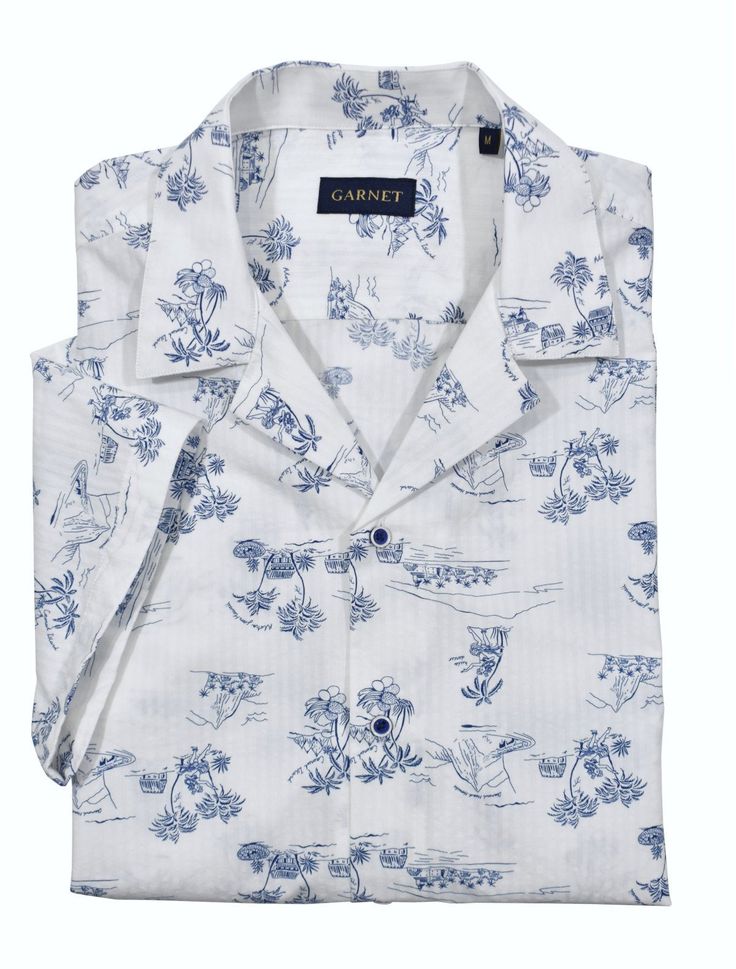 Relax and dream away in a cool casual lifestyle. Made with soft white cotton seersucker fabric and a matching island motif print in warm blue, this shirt brings a cool and comfortable look. Its pajama top collar adds to the relaxed fit, making it perfect for your island getaway. White Cotton Camp Shirt With Floral Print, White Hawaiian Shirt With Camp Collar For Vacation, Camp Collar Shirt For Daywear In Spring, Spring Camp Collar Shirt For Daywear, Spring Camp Shirt With Camp Collar For Daywear, White Relaxed Fit Hawaiian Camp Shirt, White Hawaiian Camp Shirt With Relaxed Fit, White Cotton Camp Shirt For Vacation, White Camp Shirt With Camp Collar For Spring