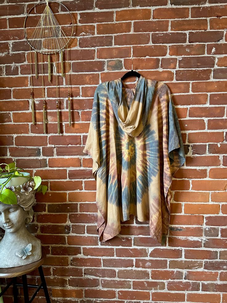 Stay cool and covered in Tie Dye with the Free Size Spiral Poncho Hoodie! Made of flowy rayon, this hoodie features armholes for a comfortable fit up to size 3X. Perfect for any boho festival or casual day out. Bust up to 55" around Arm circumference up to: 21" 30" long shoulder to hem 100% rayon hand wash gently, Air Dry Please take a moment to look over all shop policies before purchasing. Casual Poncho For Spring Loungewear, Casual Spring Poncho For Loungewear, Casual Cotton Poncho With Relaxed Fit, Casual Hooded Poncho For Festival, Oversized Hippie Tops For Fall, Bohemian Batwing Sleeve Tops For Loungewear, Bohemian Batwing Sleeve Loungewear Tops, Bohemian Loungewear Tops With Batwing Sleeves, One Size Long Sleeve Hippie Tops