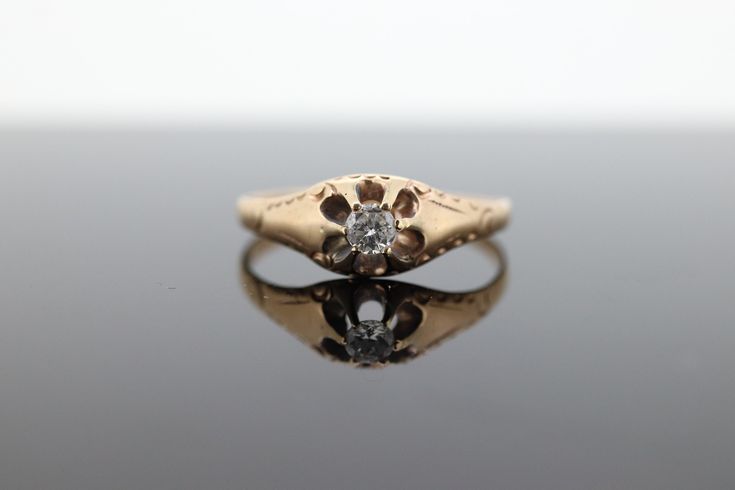 This one is an incredible find. Early 20th century 14k Yellow gold with a round diamond belcher set. Engraving on the sides. Details: 3.5mm diamond SI clarity and G color.  1.5gram total weight SZ 8.75 Will truly make a unique ring for any occasion. Antique 14k Stamped Round Cut Diamond Ring, Antique Diamond Promise Ring Stamped 14k, Antique 14k Gold Diamond Ring Stamped 14k, Antique Engraved Diamond Ring Stamped 14k, Antique Diamond Ring With Single Diamond, Antique Diamond White Ring With Single Diamond, Victorian Diamond Ring With Single Diamond, Victorian 14k Stamped Diamond Promise Ring, Victorian Style Diamond Ring With Single Diamond As Gift