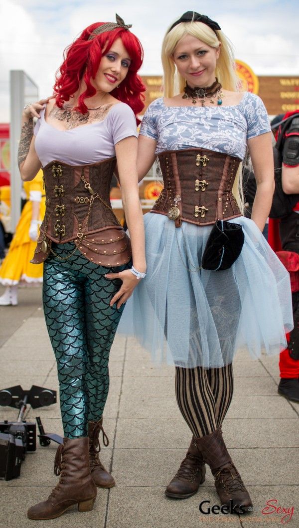 two women dressed in costumes standing next to each other