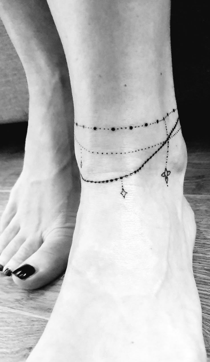 a woman's foot with a cross tattoo on it