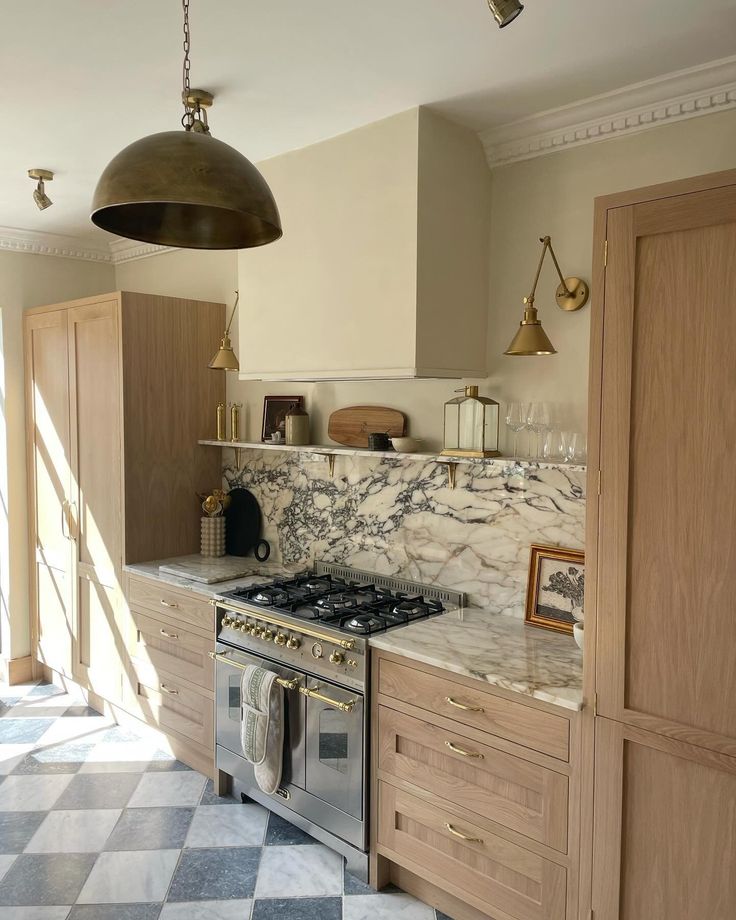 a kitchen with marble counter tops and wooden cabinets, an overhead light hangs over the stove