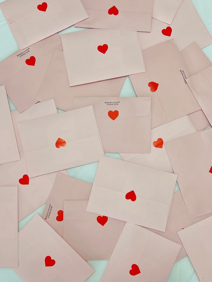 lots of envelopes with red hearts on them