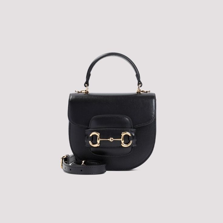 This chic little handbag is the perfect mix of elegance and versatility. Whether you're heading to a meeting or a night out, its classic design with a modern twist will have you looking flawless. Trust me, it's a must-have for any fashion-forward wardrobe. Black leather with light gold-tone metal horsebit detail Fixed top handle Adjustable and detachable shoulder strap Spring closure Two main interior compartments One interior card slot Cotton and linen lining Dimensions: 18x15x6.5cm Size nation Gucci Mini Bag, Gucci Mini, Guccio Gucci, Gucci Horsebit, Mini Handbags, Gucci Black, Black Tote Bag, Leather Mini, Black Handbags