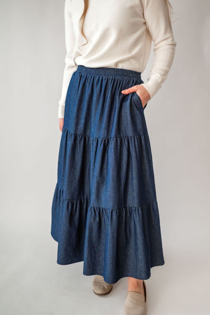 Perfect for a spring picnic or an everyday morning, the 'Celeste' skirt is so lovely and versatile! Constructed from lightweight cotton denim for a comfortable fit that moves with you, this skirt features hidden side pockets and an elastic waistband. Falling in ankle-length tiers, this comfortable skirt will compliment any simple top. Fit: true to size! Style: functioning pockets, elastic waist, tiered Color: dark wash Fabric content: 100% cotton Care instructions: wash gentle cycle, cold; lay f Spring Picnic, Comfortable Skirts, Be Intentional, Simple Top, Modest Clothing, Garment Labels, Tier Skirt, Curated Gifts, Clothes Line