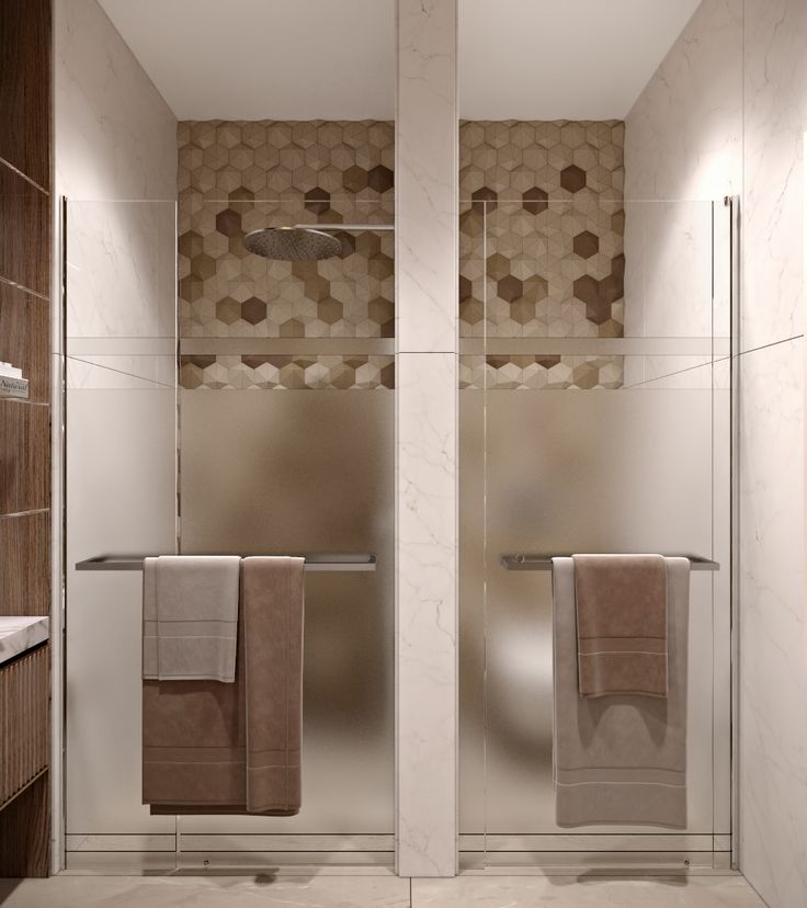 two towels are hanging on the glass doors in this modern bathroom with marble walls and flooring