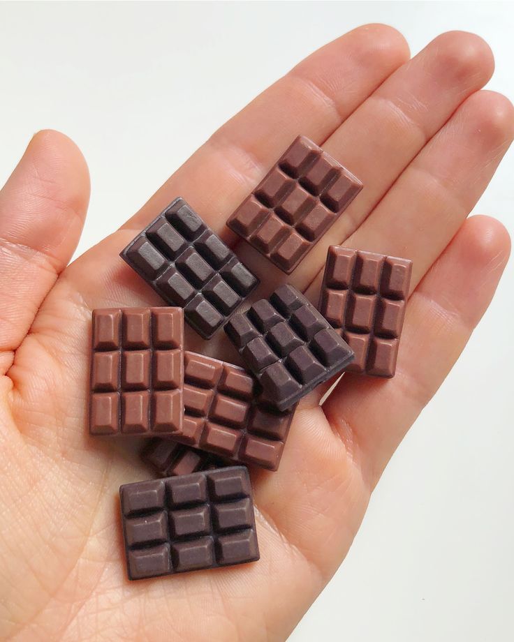 small chocolate squares in the palm of someone's hand