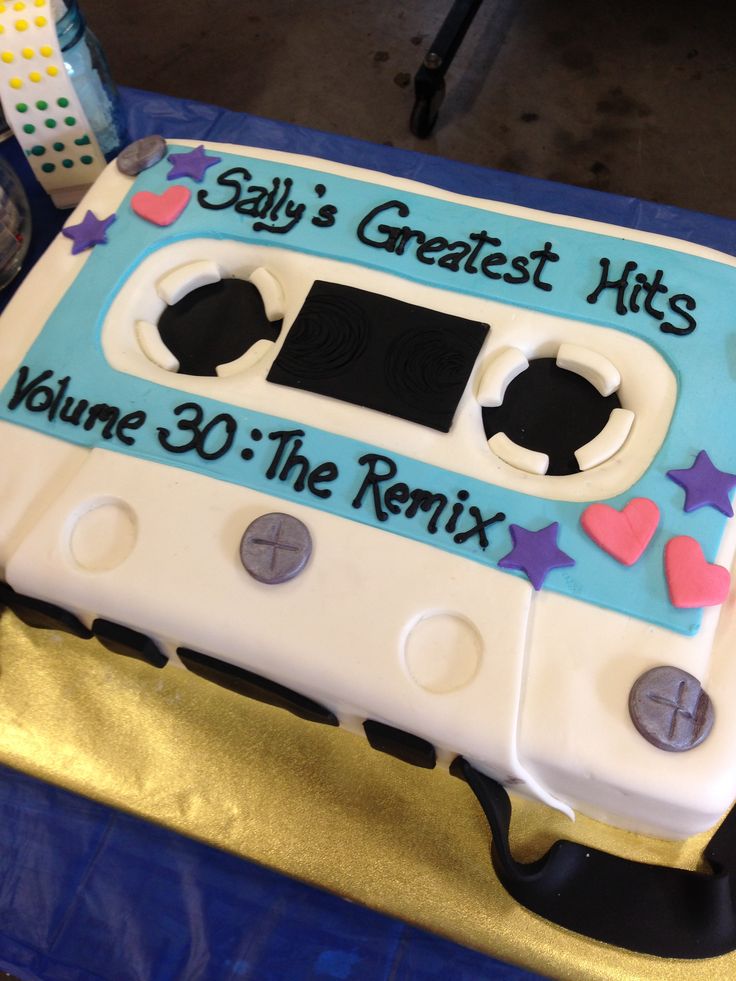 a cake shaped like an old school cassette player with stars and hearts on the side