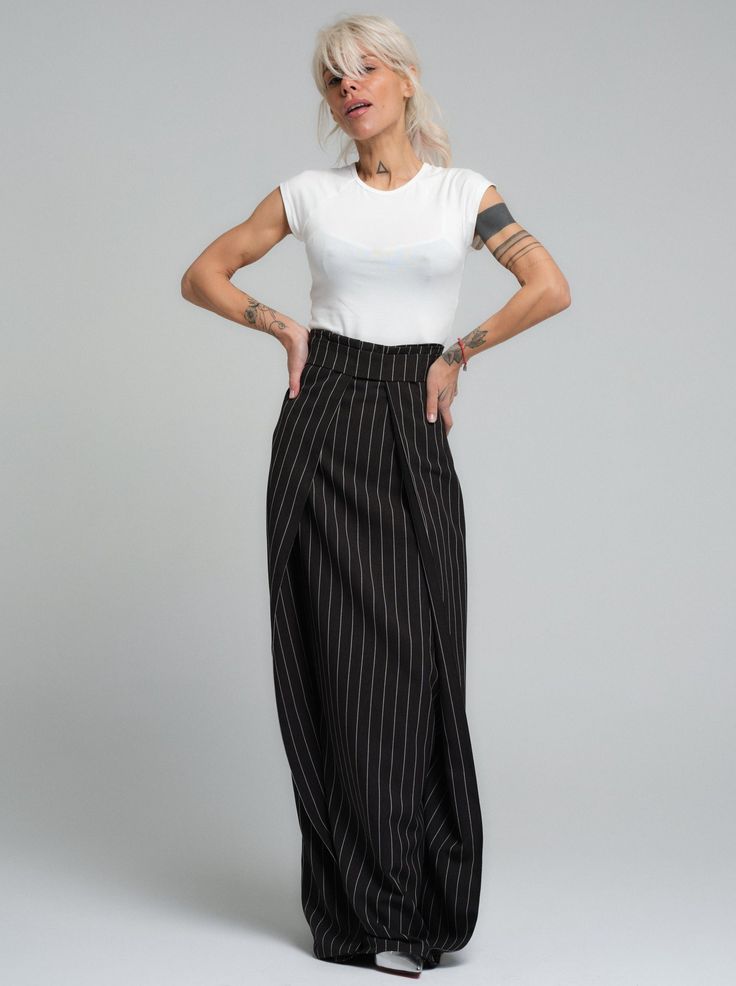 Subvert expectations in our unique maxi skirt. The high-waisted design defines your waist while the diagonal layered fabric elongates your body. FEATURES:A floor-length pinstripe maxi skirt. High-waisted design with a zipper at the back. Please note that this piece does not have pockets.100% Handmade. SIZE & FIT: Fit: A relaxed fit with room to moveModel is wearing size Small or S/M View our SIZE CHART before ordering MATERIALS & CARE: Content: Polyester Care: Machine wash on cold (30ºC) with a mild detergent. SHIPPING: Made to order, processing time is 15 working days This item will be shipped via DHL Formal Maxi Bottoms For Spring, Spring Formal Maxi Bottoms, Formal Spring Maxi Bottoms, Chic Striped Lined Maxi Skirt, Summer Formal Maxi Bottoms, Formal Summer Maxi Bottoms, Formal Pleated Maxi Length Skirt, Chic Striped Long Skirt, Chic Long Striped Skirt