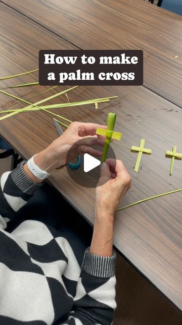 a woman is making crosses out of strips of tape on a table with the words how to make a palm cross