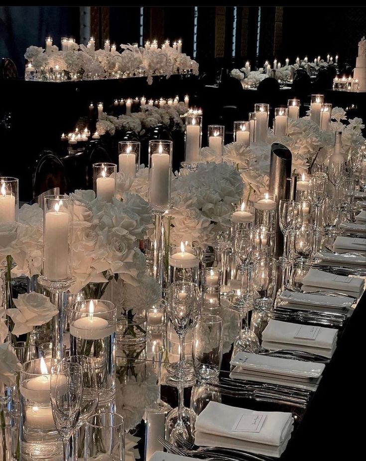 a long table with candles and plates on it