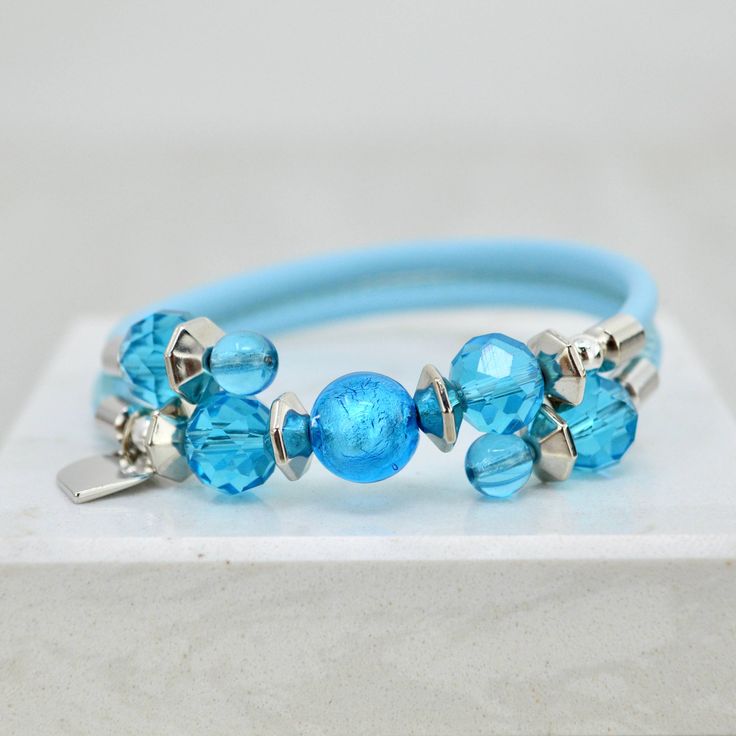 Murano Glass Rosella Beaded Bracelet Handmade Light Blue Beaded Bracelets, Blue Bangle Jewelry With Large Beads, Blue Bangle Bracelets With Spacer Beads, Turquoise Bracelets With Heart And Round Beads, Blue Bangle Bracelet With Spacer Beads, Blue Wrap Bracelet With Spacer Beads, Handmade Blue Wrap Bangle Bracelet, Blue Wrap Bracelet With Colorful Beads For Gifts, Blue Wrap Bracelet With Colorful Beads As Gift