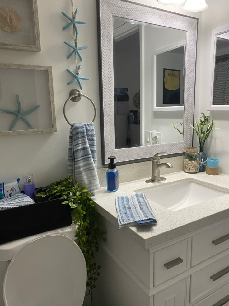 a bathroom with a sink, toilet and mirror