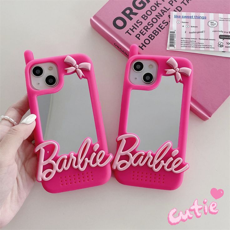 two pink cell phones with the name barbie on them and one has a bow in it