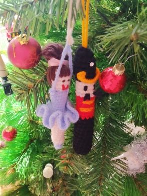 three ornaments hanging from a christmas tree in the shape of nutcrackers and princesses