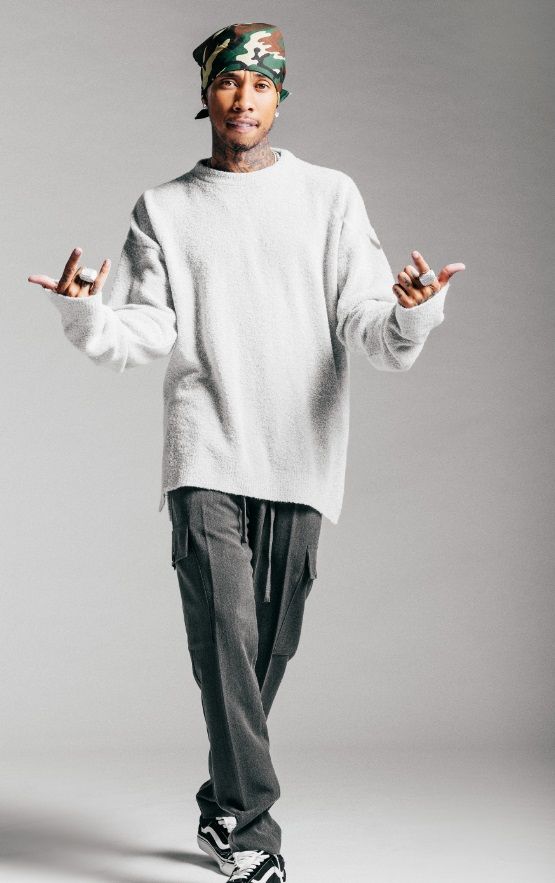 a man standing in front of a gray background