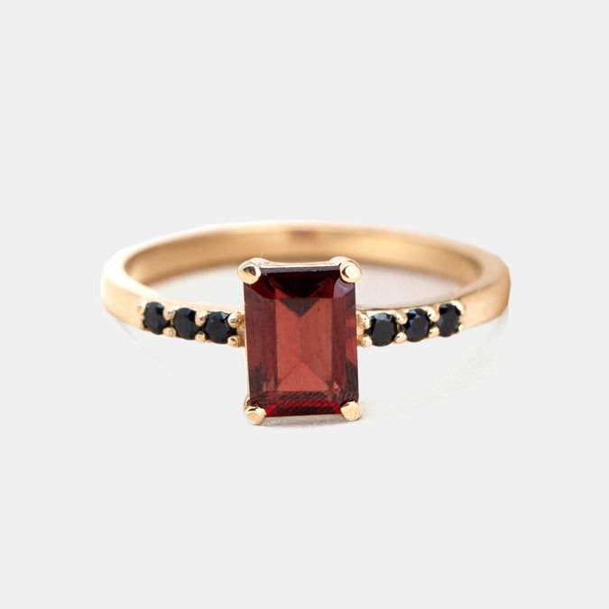 Beautifully stunning, this Deco-inspired ring features Garnet and black diamonds and is sure to turn heads. Elegant Black Ruby Ring, Classic Black Spinel Sapphire Ring For Anniversary, Black Ruby Anniversary Ring, Modern Diamond Ring With Black Diamonds As A Gift, Formal Black Rings With Ruby, Modern Diamond Ring With Black Diamonds For Gift, Modern Black Diamond Ring Gift, Classic Formal Black Spinel Rings, Classic Black Spinel Ring For Formal Occasions