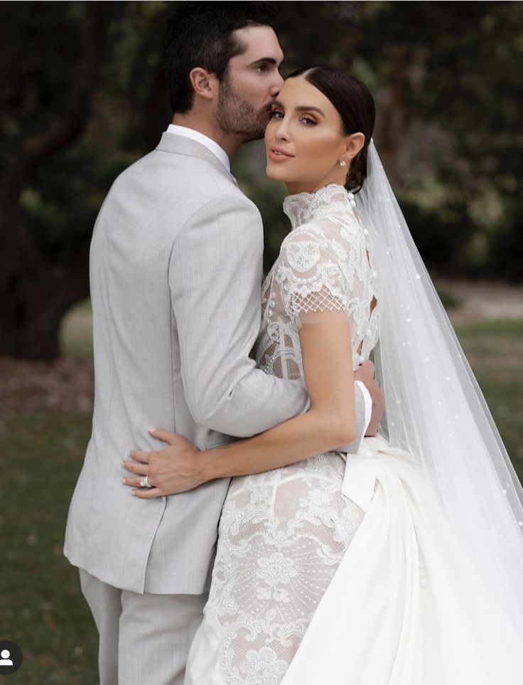 a bride and groom pose for a wedding photo