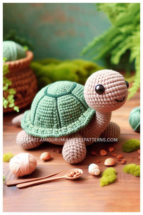 a crocheted turtle sitting on top of a wooden table next to some plants