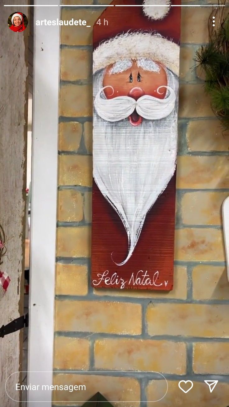 a brick wall with a santa clause painting on it