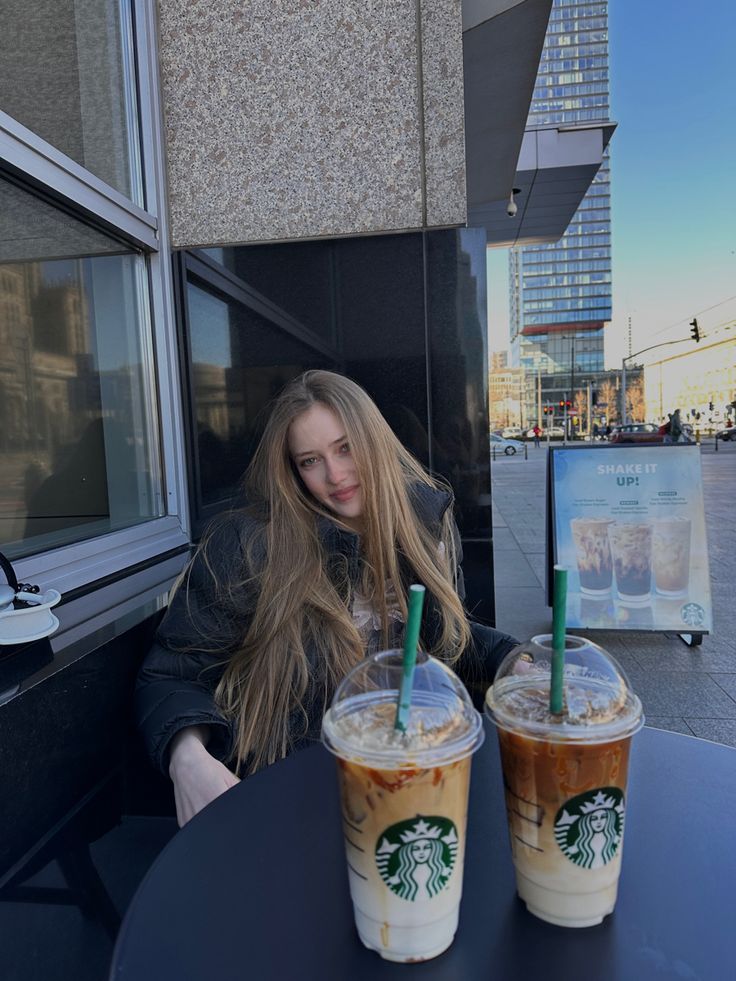 two cups of coffee sitting on top of a table