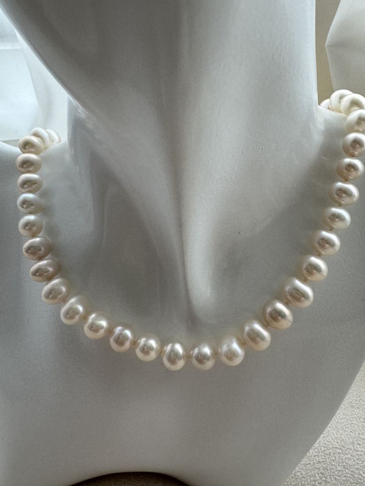 Adorn yourself with the timeless elegance of our Freshwater Egg Shape Pearl Necklace. Featuring lustrous freshwater pearls in a graceful egg shape, this necklace is a testament to refined beauty and sophisticated style. Features: Material: Genuine freshwater egg shape pearls and high-quality, hypoallergenic stringing material. Pearl Size: Each egg-shaped pearl measures approximately 7-9mm, offering a smooth, symmetrical design. Necklace Length: 17 inches. Clasp: Secure and elegant platinum-plated lobster claw clasp for ease of wear and removal. Design: Classic and versatile, perfect for both casual and formal occasions. Benefits: Elegant Design: The smooth, egg-shaped pearls exude a sophisticated charm, adding a touch of luxury to any outfit. Versatile Wear: Suitable for weddings, parties, Elegant Oval Necklace With Pearl Charm, Elegant Pearl White Oval Necklace, Elegant Oval Pearl White Necklace, Classic Pear-shaped Pearl Necklace With Charm, Classic Pear-shaped Pearl Necklace, Elegant Oval Bead Pearl Jewelry, Elegant Pearl Jewelry With Oval Beads, Pear Shaped Pearl Necklace For Formal Occasions, Elegant Oval Pearl Necklaces