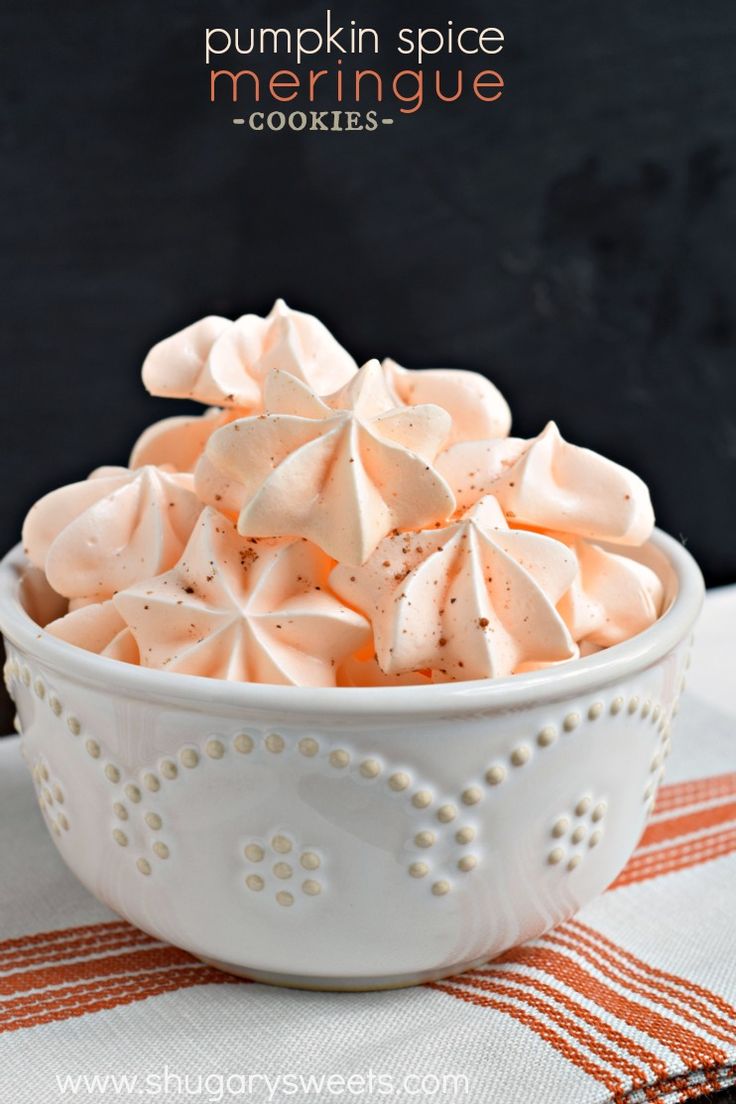 a white bowl filled with marshmallows on top of a table