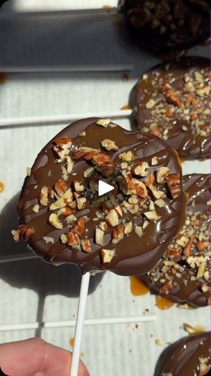 chocolate covered donuts on a stick with nuts