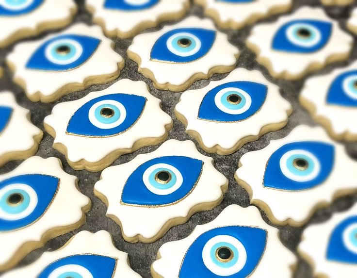 blue and white decorated cookies with evil eyes on them are arranged in the shape of an eye